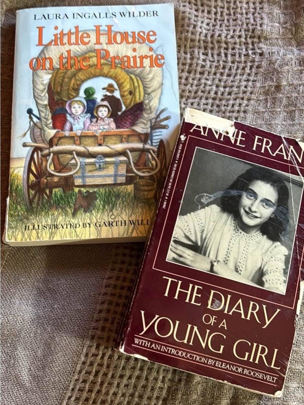 paperback books Little House on the Prairie and diary of a young girl
